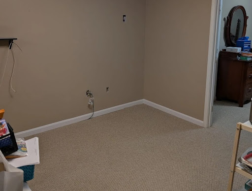 After restoration photo of a clean carpeted basement room.