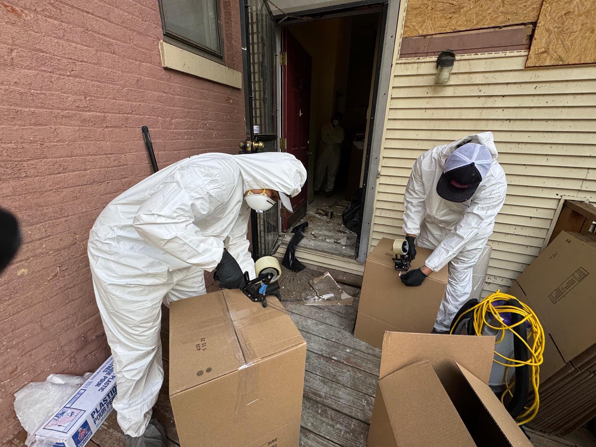 Monarch Restoration specialists boxing homeowner's items for safe storage.