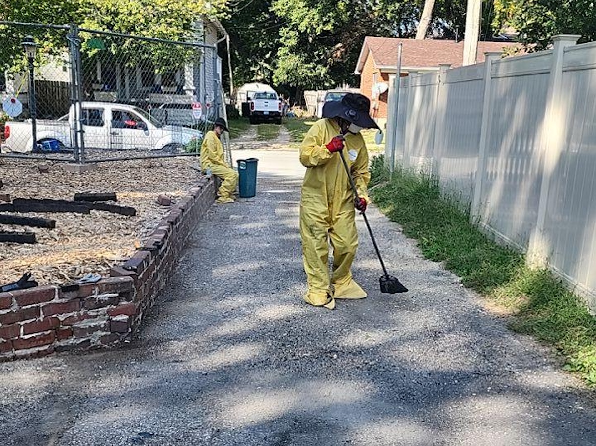Monarch Restoration specialists cleaning exterior of home.